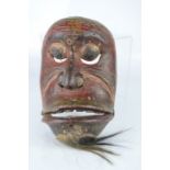 An African carved tribal face mask.