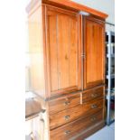 A mahogany Edwardian cupboard, the upper section having two cupboard doors, above two short over two