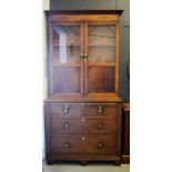A Welsh cupboard, the upper glazed doors above a chest of two over three long drawers.