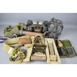 A group of militaria to include a telephone, clacker, gun cleaning kits in tins, and other items.