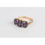 A 9ct gold and amethyst ring, three oval cut amethysts in claw setting, size Q, 4.4g.