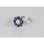 An 18ct white gold, diamond and sapphire flowerhead ring.