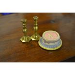 A pair of miniature brass candlesticks, and a dolls house miniature cake.