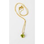 A 9ct gold and green peridot heart form pendant with necklace.