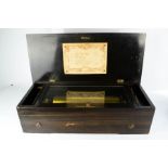 A 19th century music box, with eight songs, in a mahogany case inlaid with marquetry musical group.