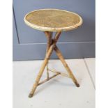 A bamboo table with circular wicker top.