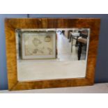 A rectangular walnut veneered bevelled plate mirror.