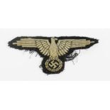 A German cloth eagle badge, possibly removed from uniform.