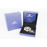 A Swarovski brooch in the original box.