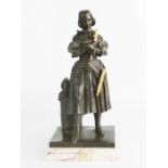 A bronze figure of Joan of Arc raised on a marble base.