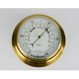 A Tempora aneroid barometer, 20cm diameter.