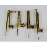 Four brass pencil dividers of various form.