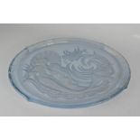 A glass tray, pressed with mermaids.