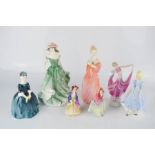 A group of four Royal Doulton figurines including Paisley Shawl, and Sweet Anne, 10cm high, and