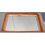 An overmantle mirror with inlaid border.