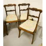 Three Regency sabre leg dining chairs, with wicker seats and drip in upholstered cushions.