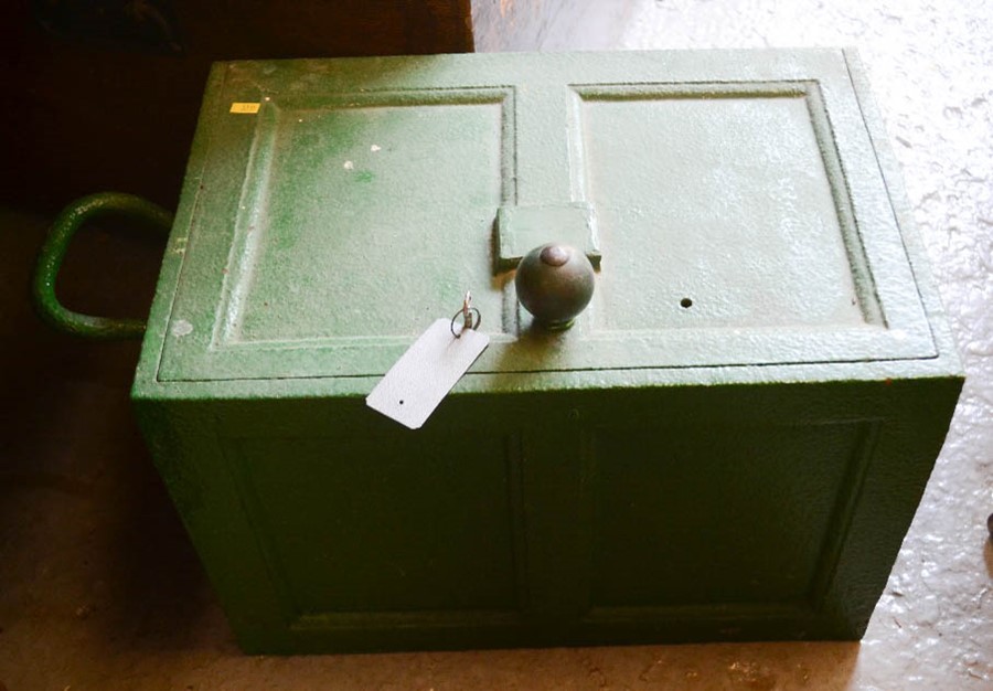 An antique green painted safe.