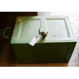 An antique green painted safe.
