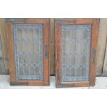 A pair of lead and glass doors. A/F