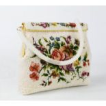 A beaded and needlework clutch bag, depicting flowers.