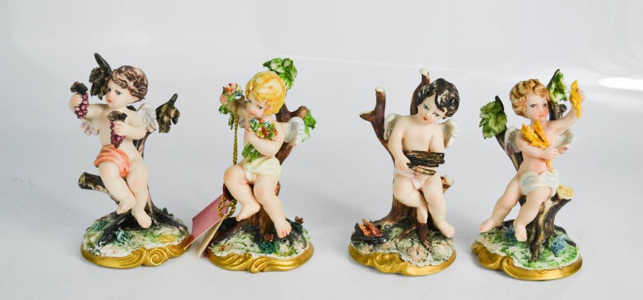 Four Capodimonte cherub figures.