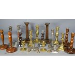 A quantity of candlesticks; brass, treen and silver plated examples.