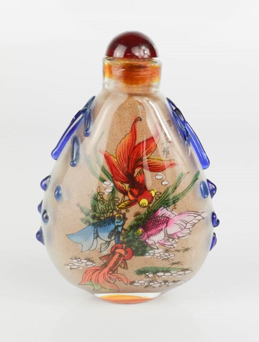 A Chinese reverse painted snuff bottle depicting a goldfish, signed by the artist.
