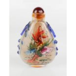 A Chinese reverse painted snuff bottle depicting a goldfish, signed by the artist.