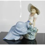 A Nao Lladro figure of girl and bird.