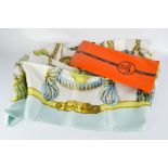 A Hermes of Paris Frontaux et Cocardes scarf with original packaging.