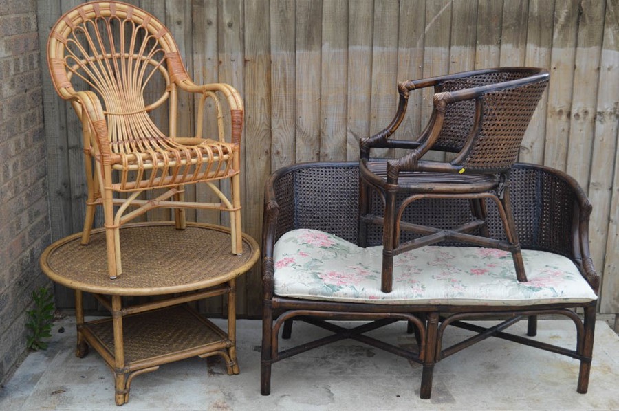 A wicker coffee table and matching seat together with two conservatory chairs.