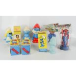 A group of Smurfs, Noddy, novelty toothbrush holder and other items.