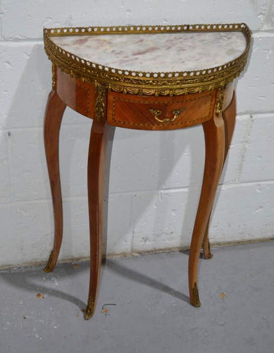 A French demi lune table, in kingwood, with marble top and gallery rail.