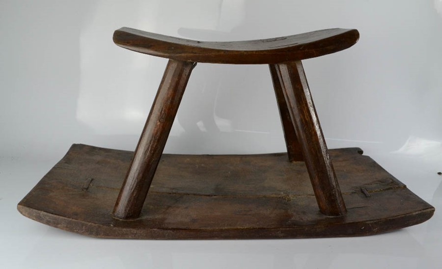 An African antique rocking stool.