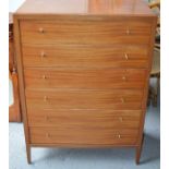 A chest of drawers, with six drawers, a desk and 2 small chests of drawers.