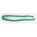 A Chinese Heitian heavy green jade bead necklace, having miau silver screw clasp.