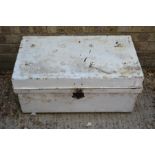 A white painted tin trunk.