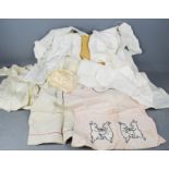 A quantity of children's clothing, to include silk dresses, cotton examples, a tunic embroidered