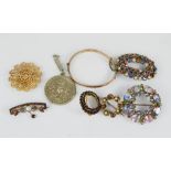 A group of brooches, a Victorian example and a rolled gold bracelet.