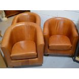 A group of three Marks & Spencer tan leather tub chairs.