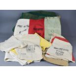 A group of early 20th century bank money bags, linen sacks for seed and food and other fabric.