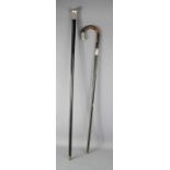 Two ebonised and silver walking sticks.