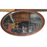 A 19th century mahogany wall mirror, oval form, inlaid with stringing.