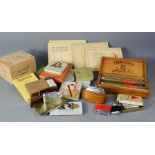 A quantity of tobacconist items; lighters, box of cigar cases, tins and four cigarette card albums.