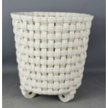 A ceramic basket weave jardinere.