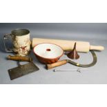 A group of kitchenalia including a rolling pin, flour sifter, funnel, scythe, herb cutter and