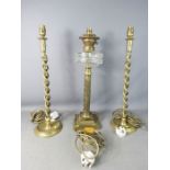 A Victorian oil lamp together with a pair of brass candlesticks with twisted columns.