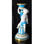 A Minton cherub candlestick, with gilded highlights, 23½cm high.