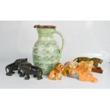 A collection of ceramic lions and a jug.