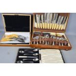 An oak cased canteen of cutlery together with an oak cased grapefruit set.